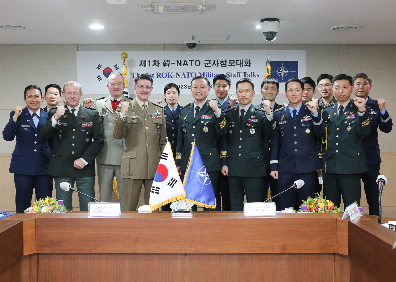 Maj. Gen. Kim Su-kwang (C), head of the directorate of strategic planning at the Joint Chiefs of Staff (JCS), and Lt. Gen. Francesco Diella (5th from L), director of NATO`s cooperative security division, take a group photo as they take part in military staff talks between the two sides on Feb. 13, 2023, in this photo provided by the Joint Chiefs of Staff.