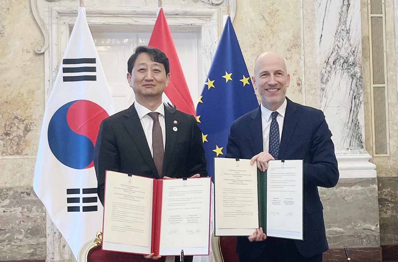 This photo shows Trade Minister Ahn Duk-geun (on the left) posing for a photo with Austria's labor and economic minister, Martin Kocher, after signing a memorandum of understanding on industry and trade cooperation in the European country on Thursday. (S.Korea's Industry Ministry)