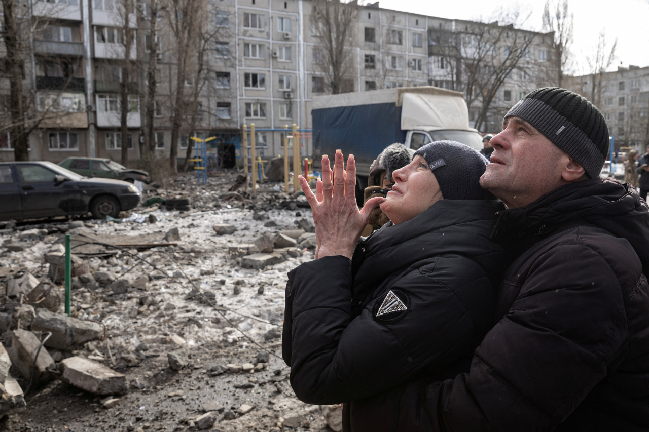 A woman reacts as her brother is rescued after an apartment block was heavily damaged by a missile strike, amid Russia's attack on Ukraine, in Pokrovsk, Donetsk region, Ukraine, February 15, 2023. (Photo - Reuters)