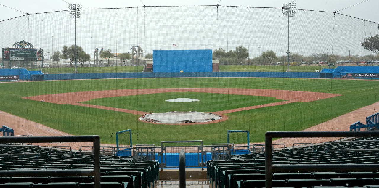 The home plate and the mound at Kino Veterans Memorial Stadium in Tucson, Arizona, on Wednesday, are covered with a tarp before a scrimmage between South Korea and the KT Wiz ahead of the World Baseball Classic. (Yonhap)