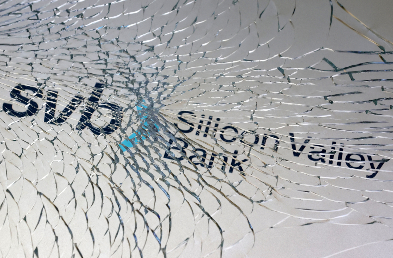 SVB logo is seen through broken glass in this illustration taken Friday. (Reuters)