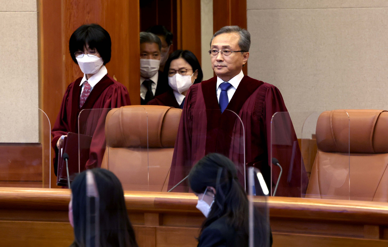Constitutional Court of Korea judges, including Chief Justice Yoo Nam-seok (right), are seen entering the courtroom on Thursday. (Yonhap)