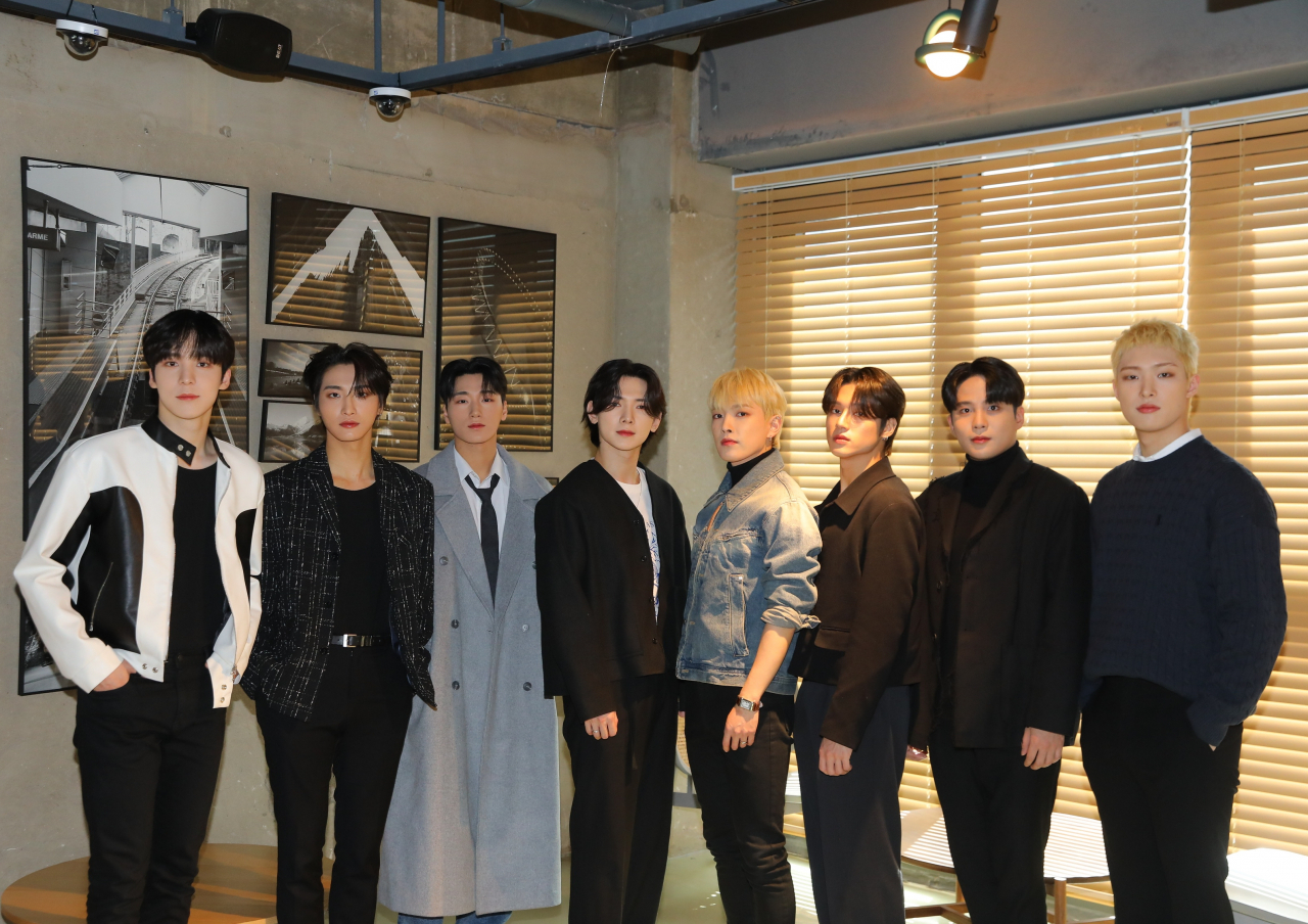 Ateez members pose for pictures during an interview held in Seoul on Wednesday. (KQ Entertainment)