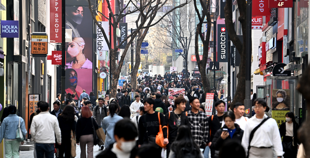 People walk on the main street in the Myeong-dong area, Seoul, on Wednesday. The commercial district of Myeong-dong has been revitalized since last year, particularly after the South Korean government lifted major travel restrictions that were imposed during the COVID-19 pandemic. Increases in the number of Japanese tourists to South Korea has been reported, whereas the number of Chinese travelers remained low amid sour diplomatic relations between the two countries. (Im Se-jun/The Korea Herald)