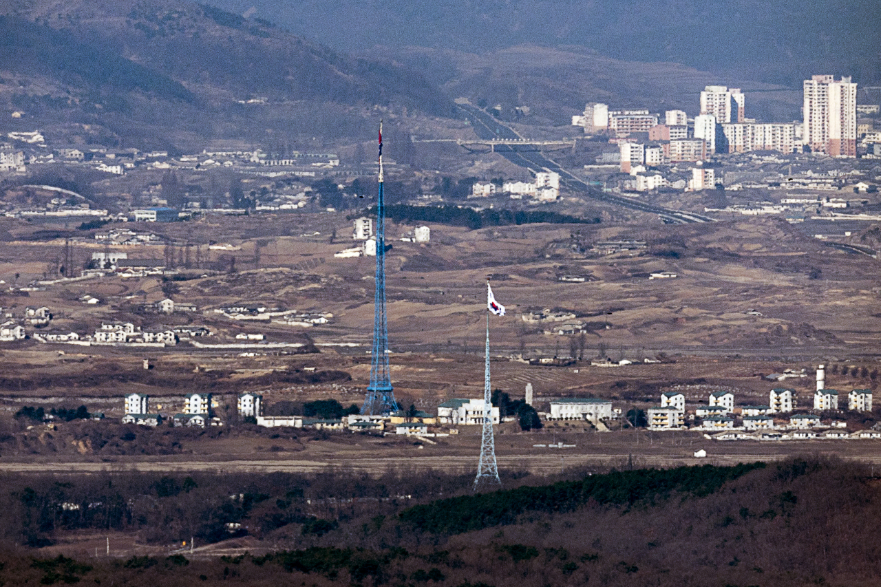 A South Korean flag in the South's Daeseong-dong and a North Korean flag in the North's Kijong-dong face each other on the western border in this photo taken from the South Korean border city of Paju on March 13, 2023.