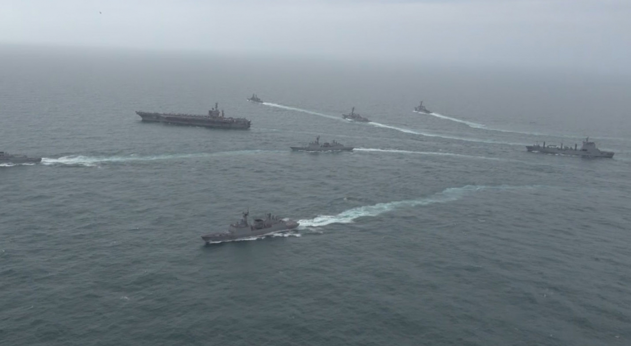 Photo released by the South Korean Navy shows South Korean, US, and Japanese warships conducting trilateral drills in the international waters south of the Korean Peninsula on April 4. (Yonhap)