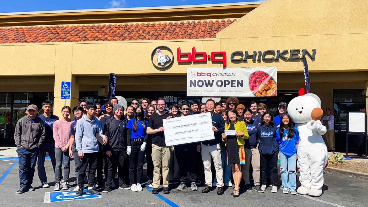 Genesis BBQ staff pose for a photo with students from Fountain Valley High School during a donation ceremony in front of the new restaurant in Fountain Valley, California. (Genesis BBQ)