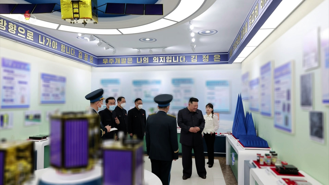 North Korean leader Kim Jong-un (second from right) with his daughter Ju-ae (far right), visits the National Aerospace Development Administration in Pyongyang, North Korea, on Tuesday in this photo provided by the North's official Korean Central News Agency. (Yonhap)