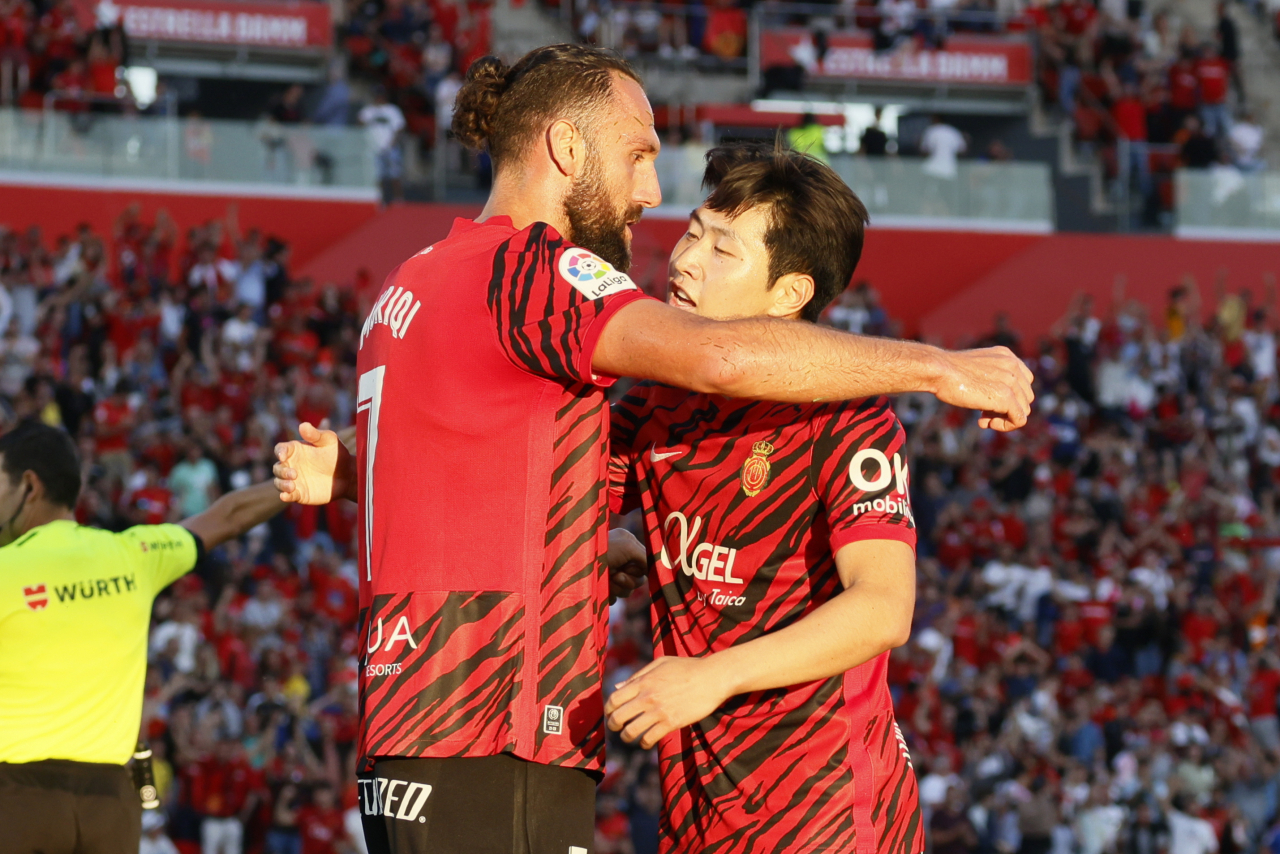 Lee Kang-in of RCD Mallorca (right) celebrates with teammate Vedat Muriqi after scoring a goal against Athletic Club during the clubs' La Liga match at Estadi Mallorca Son Moix in Palma de Mallorca, Spain, on Monday. (EPA)
