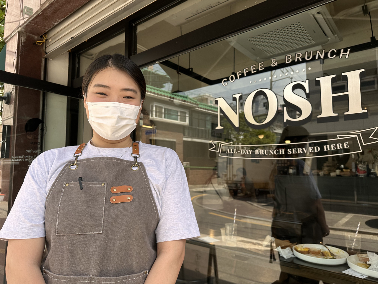 Lee Da-ye, Nosh’s owner and chef, stands in front of the all-day brunch restaurant, near Sindaebang Station in Gwanak-gu, southwestern Seoul, on April 28. (Ali Abbot/The Korea Herald)