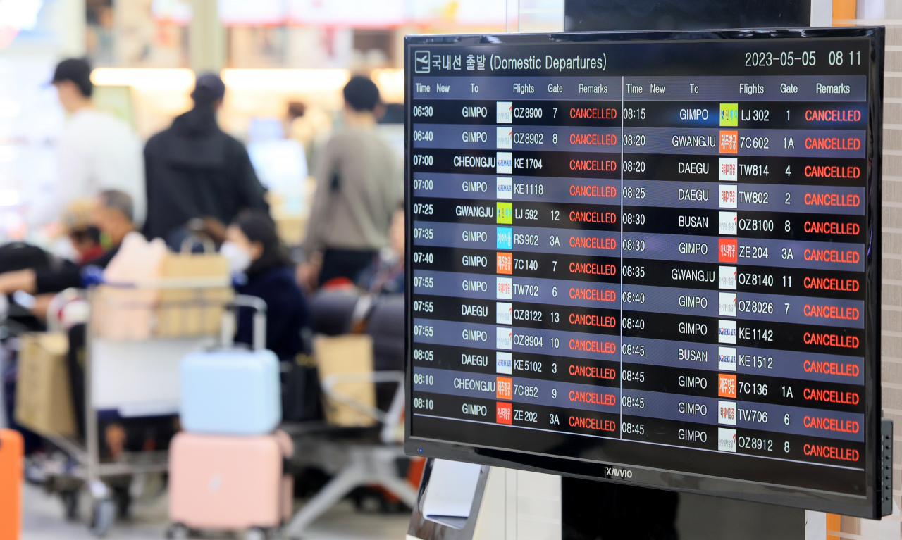The flight information display system at the Jeju International Airport informs passengers about the flights canceled on Friday. (Yonhap)