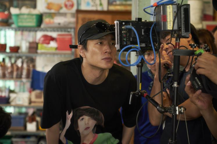 Director Lee Byeong-heon looks into the monitor while shooting for 