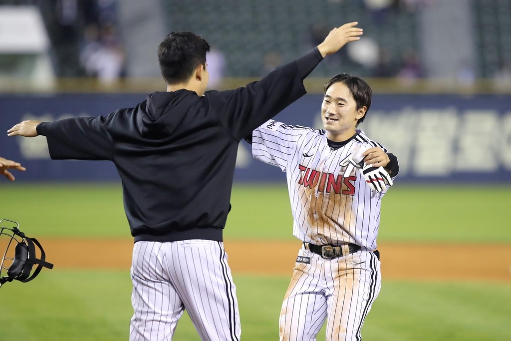 Shin Min-jae of the LG Twins (right) celebrates his game-winning hit against the Kiwoom Heroes after a 5-4 victory in a Korea Baseball Organization regular season game at Jamsil Baseball Stadium in Seoul on Tuesday in this photo provided by the Twins. (Yonhap)