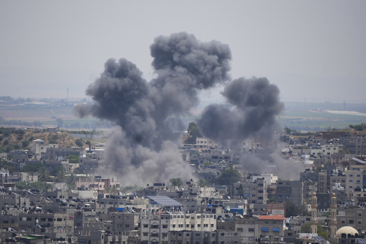Smoke rises from an explosion caused by an Israeli airstrike, in Gaza Strip, Friday. (AP)