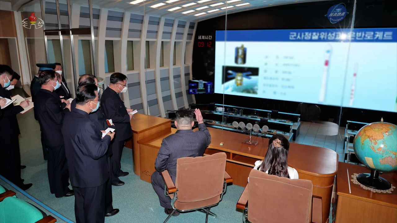 North Korean leader Kim Jong-un (center), along with his daughter Ju-ae (right), visits the National Aerospace Development Administration in Pyongyang on April 18, 2023, in this photo provided by the North's official Korean Central News Agency. (Yonhap)