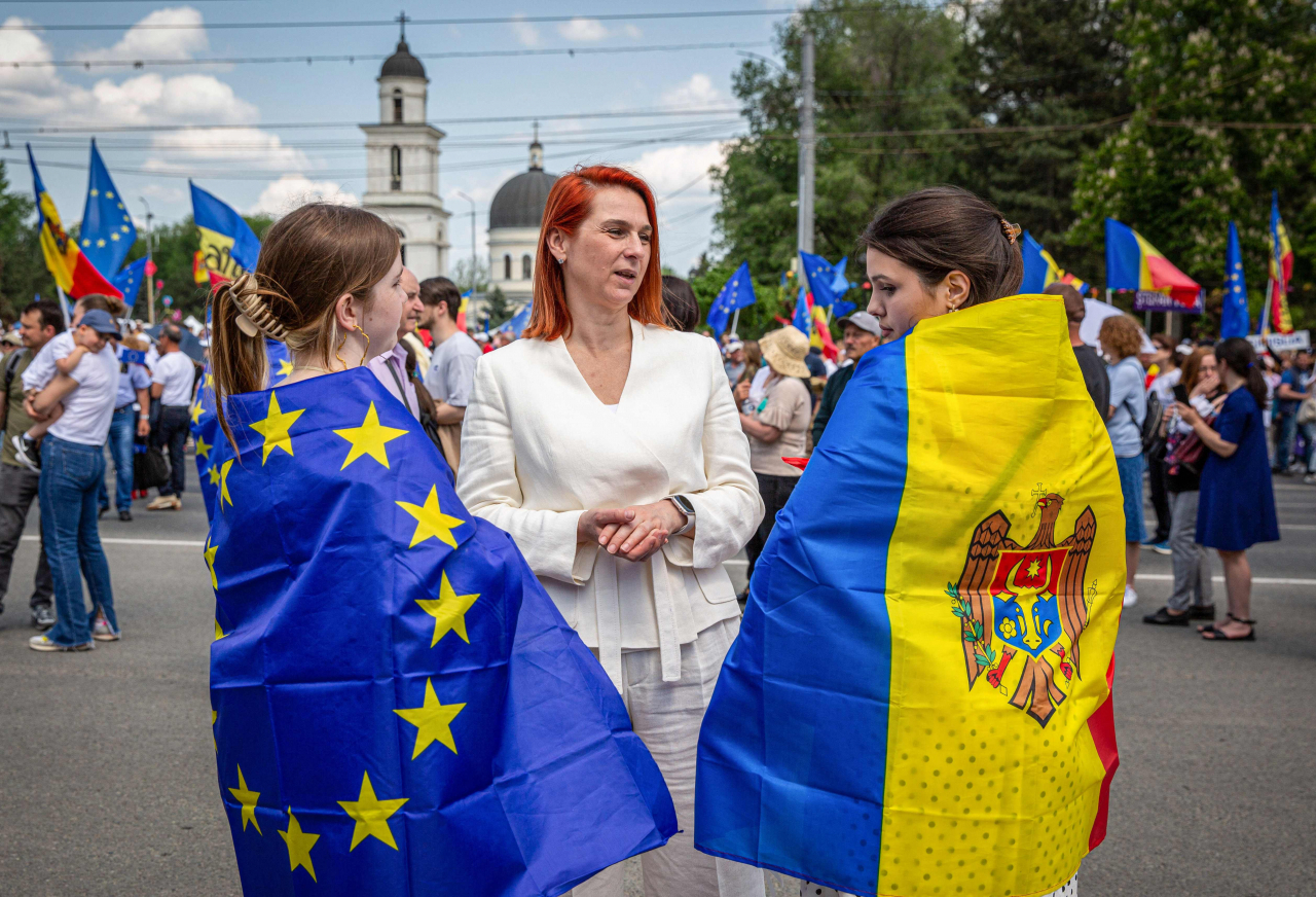 People wearing the Moldovan flag and the EU flag across their shoulders, takes part in a pro-EU rally in Chisinau on Sunday. (AFP-Yonhap)