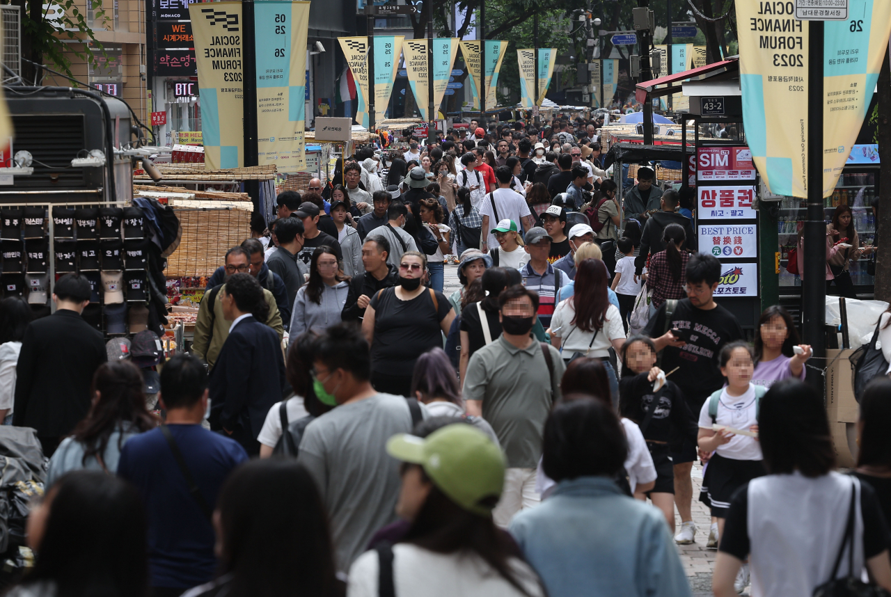 This photo, taken last Sunday, shows a street packed with people in the popular tourist district of Myeongdong in central Seoul. (Yonhap)
