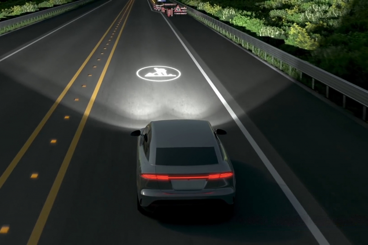 Hyundai Mobis’ latest lighting system projects real-time driving information on the road at night such as a construction warning sign for drivers and a crosswalk for pedestrians. (Hyundai Mobis)