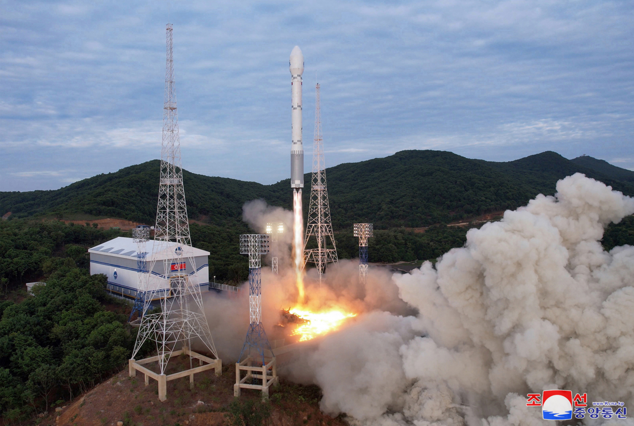 This photo shows the launch of the North's new Chollima-1 rocket, allegedly carrying a military reconnaissance satellite, Malligyong-1, from Tongchang-ri on the North's west coast Wednesday. (KCNA)