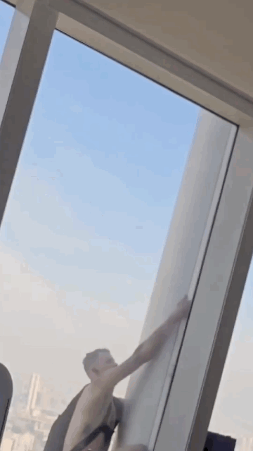A man is seen climbing the Lotte World Tower, a 555-meter skyscraper, in this video shot from inside the building. (Courtesy of reader)