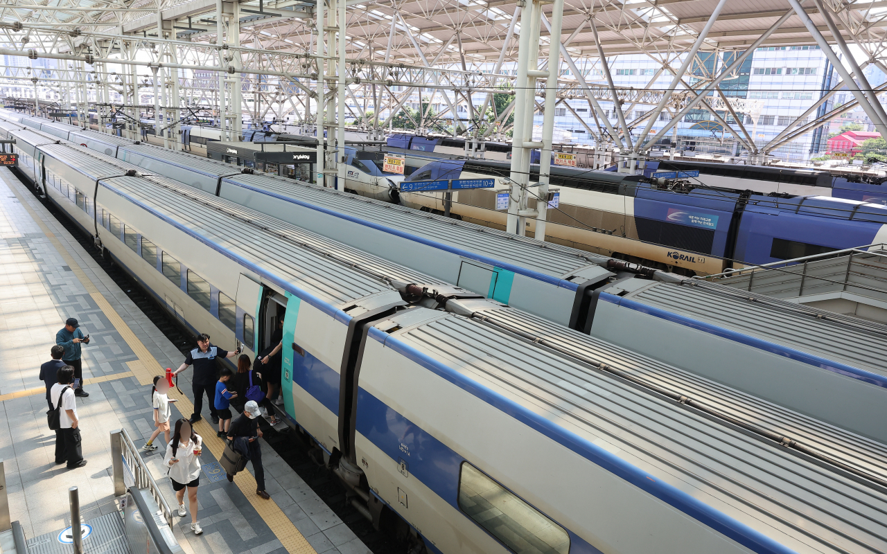 People board a KTX train at Seoul Station.