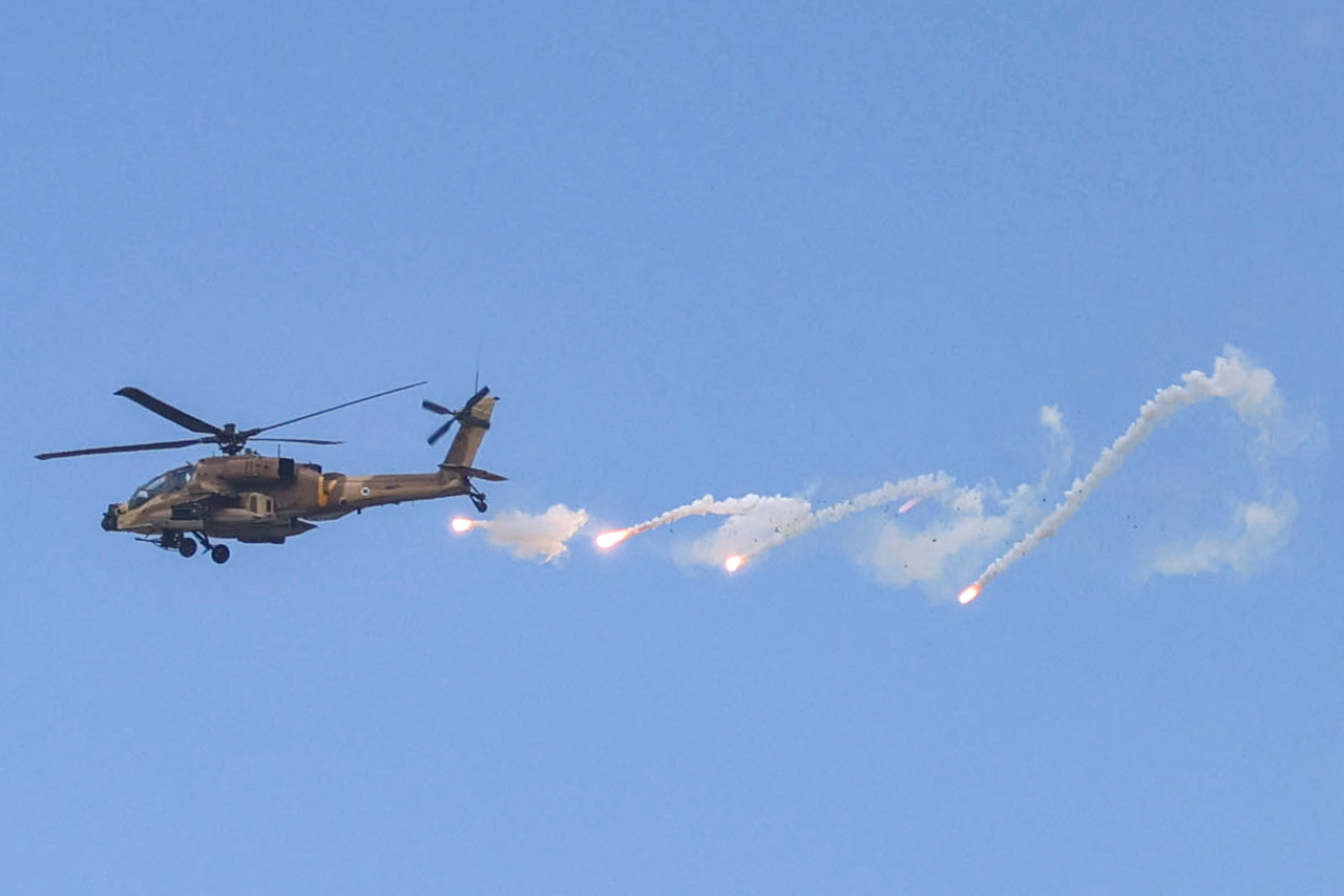 An Israeli Air Force AH-64 Apache attack helicopter releases a payload during an Israeli army raid in Jenin in the occupied West Bank on Monday. (AFP)