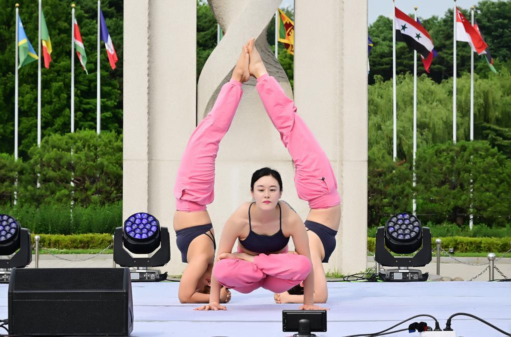 Attendees showcase different yoga positions at the 9th International Day of Yoga hosted by the Indian Embassy in Olympic Park's Peace Plaza in Seoul on Saturday. The event was attended by more than 600 yoga enthusiasts and practitioners embracing the spirit of yoga. The celebration showcased many activities such as common yoga protocols, yoga demonstrations and meditation sessions conducted by yoga instructors.