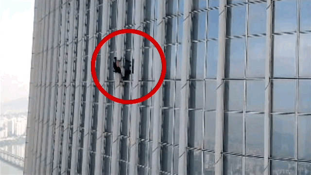 A British man ascends outside the 72nd floor of the Lotte World Tower in Songpa-gu, Seoul, as he attempted free climb the world's fifth-tallest building. (Songpa Fire Station)