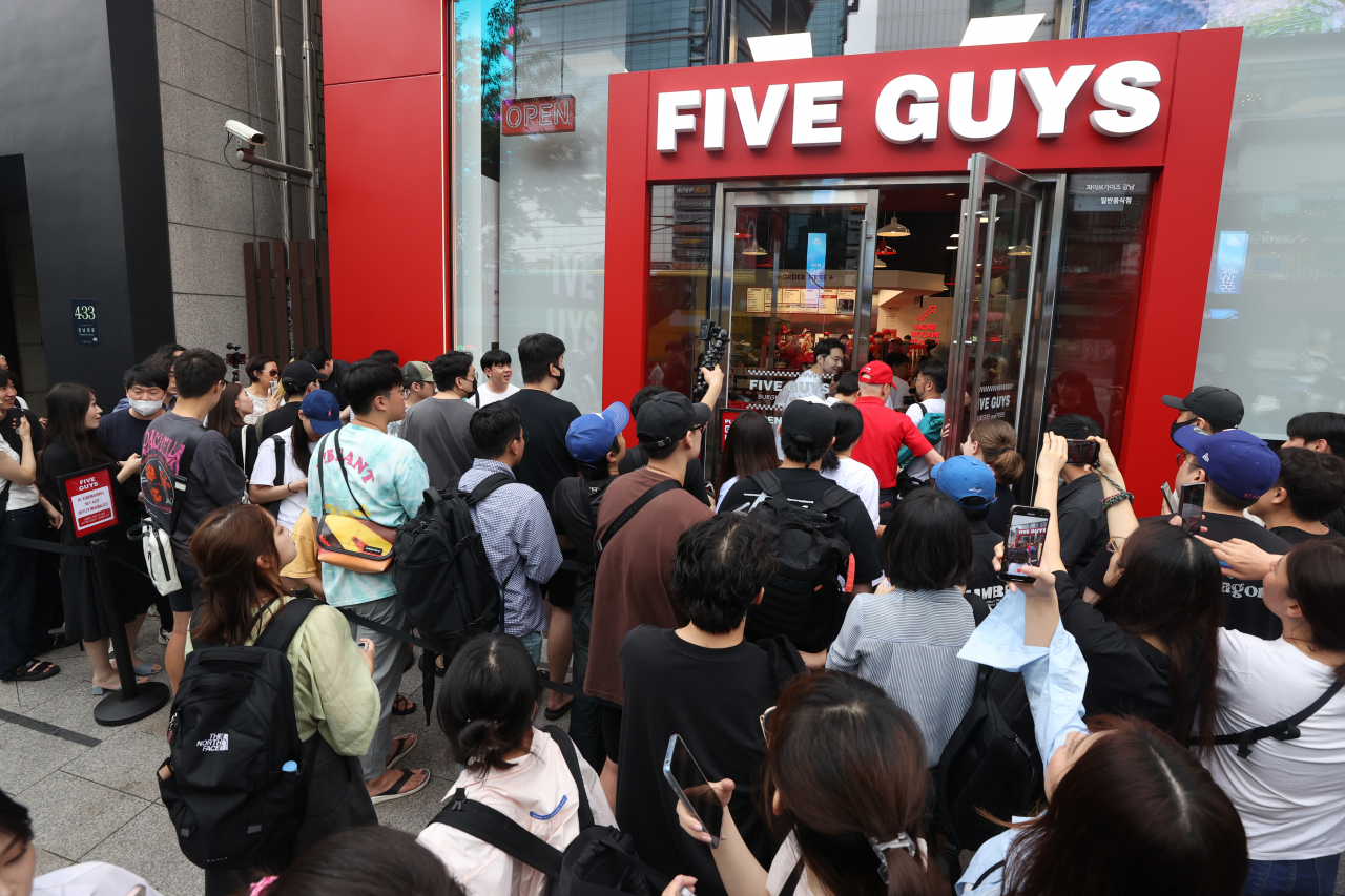 A large crowd waits for the opening of the first Five Guys restaurant in South Korea in Gangnam-gu, Seoul, on Monday. (Yonhap)