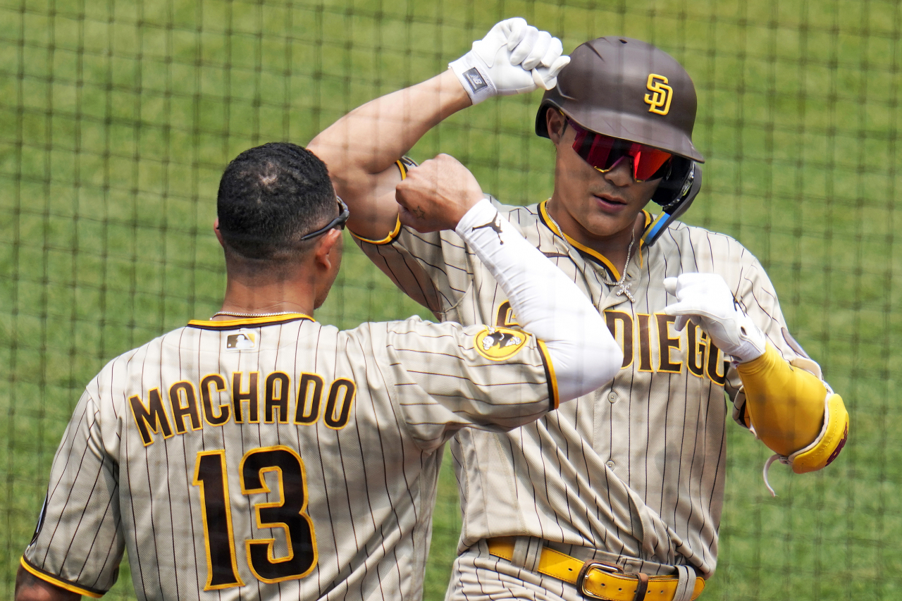 San Diego Padres' Ha-Seong Kim, right, celebrates with Manny Machado as he returns to the dugout after hitting a solo home run off Pittsburgh Pirates starting pitcher Luis Ortiz during the fourth inning of a baseball game in Pittsburgh, Thursday. (AP Photo/Gene J. Puskar)