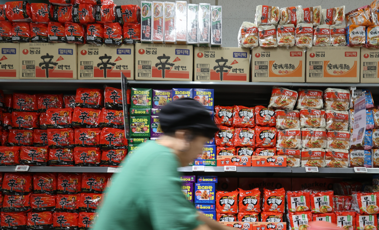 A customer shops for groceries at a supermarket in Seoul on July 2. (Yonhap)