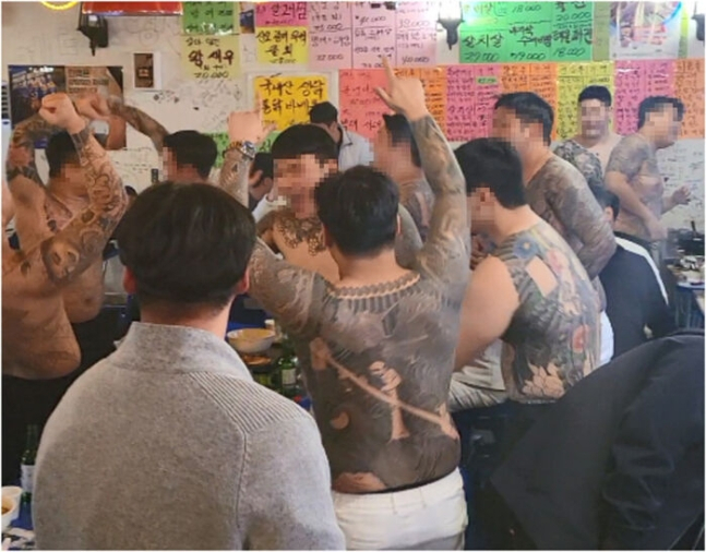 South Korean gang members are seen cheering in this photo released by the Seoul Central District Prosecutors Office. (Seoul Central District Prosecutors Office)