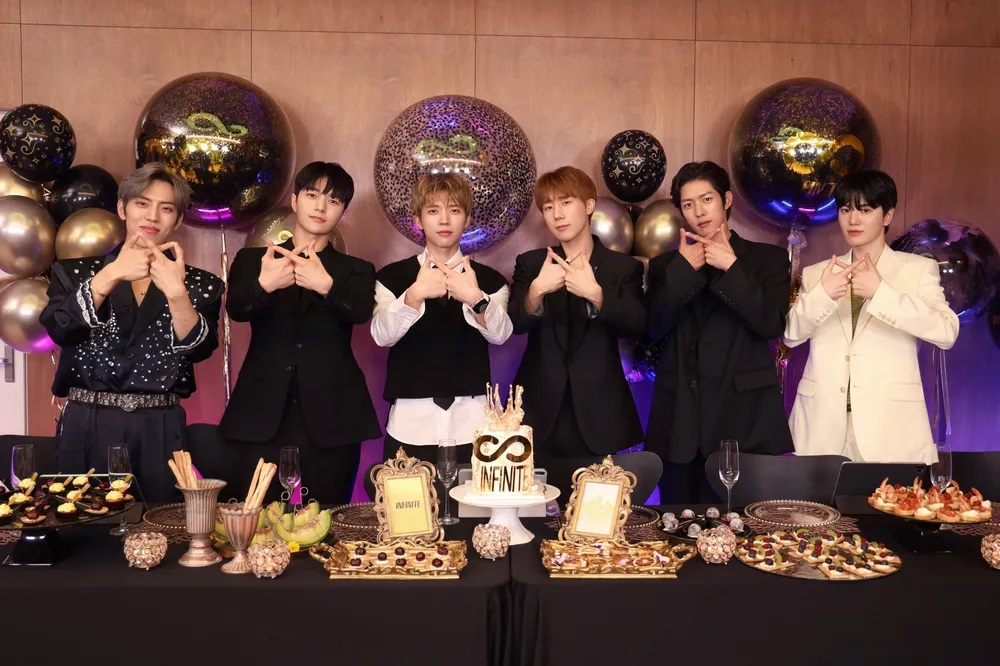 Infinite members pose for a picture during the band's 13th anniversary YouTube broadcast held on June 9. (Screenshot of the video)