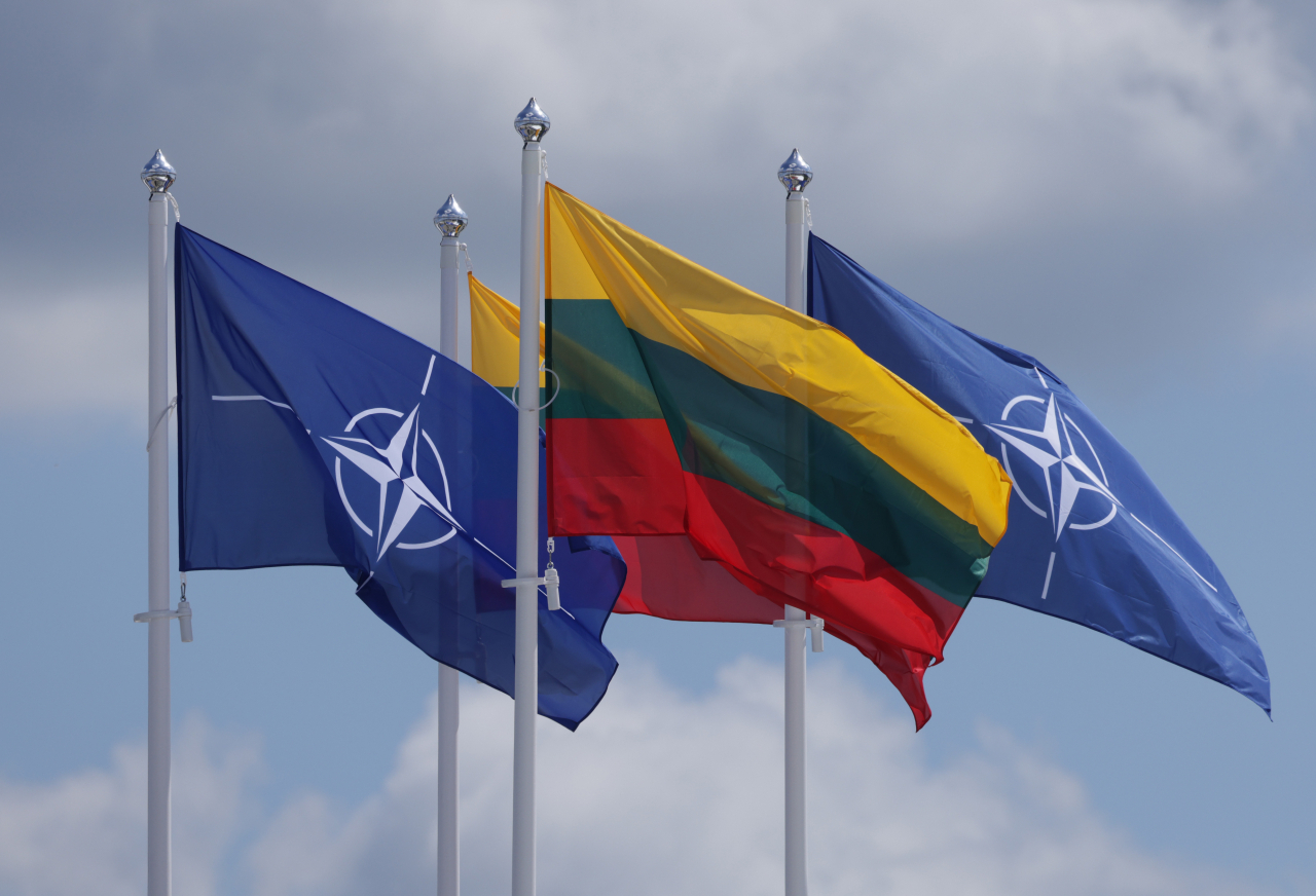 The NATO and Lithuanian flags fly over the summit venue on Sunday in Vilnius, Lithuania. Vilnius is scheduled to host the 2023 NATO Summit. (Getty Images)