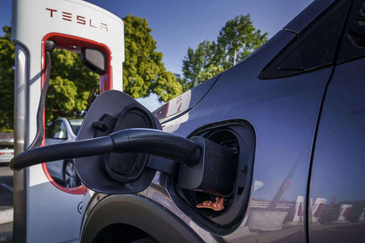 A Chevrolet Bolt electric compact charges at a Tesla Supercharger in Scotts Valley, California, US, on June 1. Tesla is making its ubiquitous Superchargers available to other EVs through new corporate partnerships. (Bloomberg)