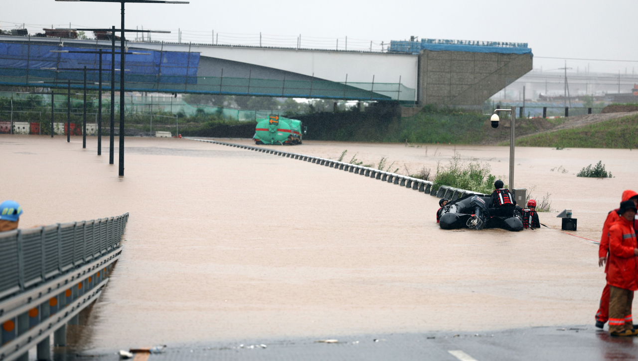 A rescue operation is under way on a submerged underground road in the central city of Cheongju on July 15, 2023. At least 19 vehicles, including a passenger bus, are feared to have been submerged. (Yonhap)