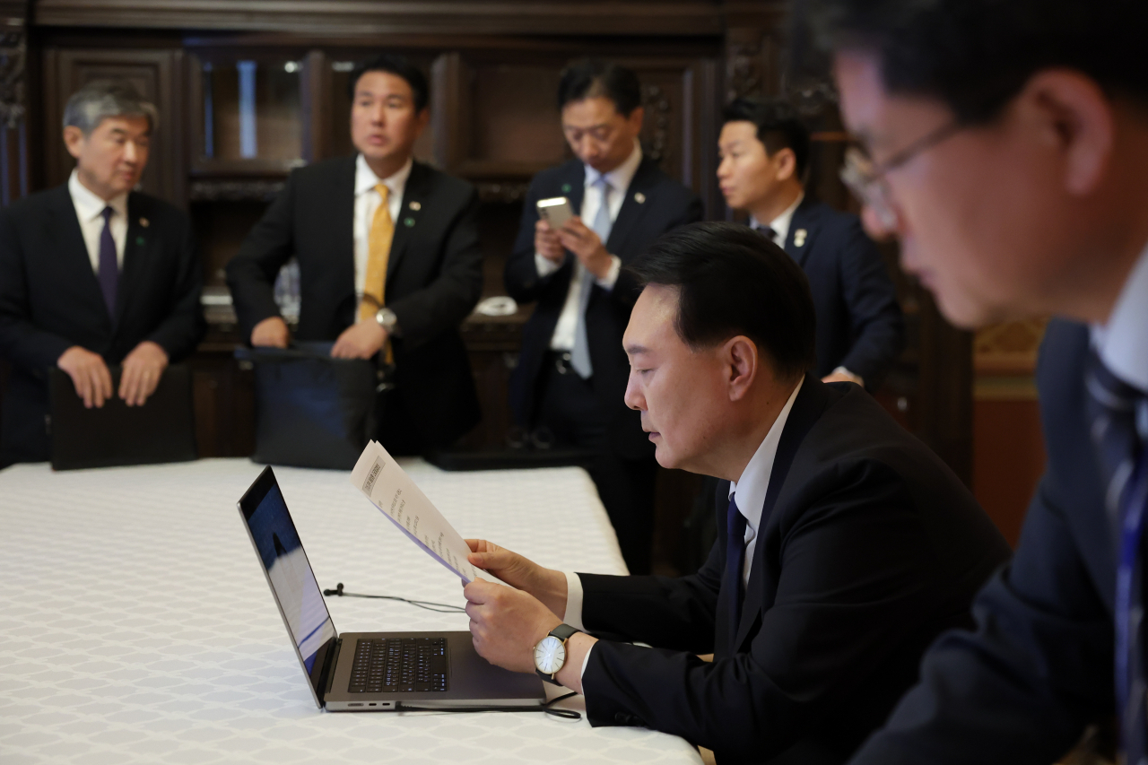 President Yoon Suk Yeol holds a meeting with his aides on the government's response to heavy rains in South Korea on Saturday. (Presidental office)