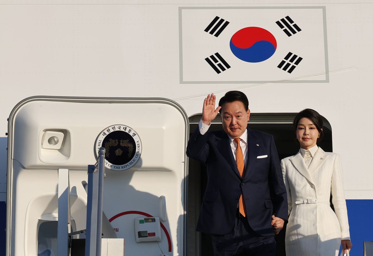 President Yoon Suk Yeol (right) and first lady Kim Keon Hee board the presidential plane at Seoul Air Base, just south of the capital, on July 10, to depart for Lithuania. (Yonhap)