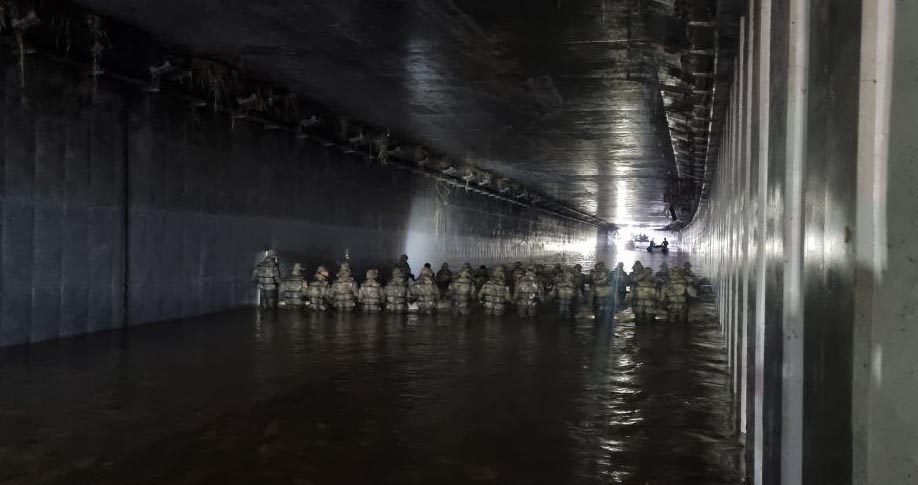 Officials of the Korea Coast Guard on Monday conduct a rescue operation inside the underpass in Cheongju, North Chungcheong Province, which flooded Saturday. (Yonhap)
