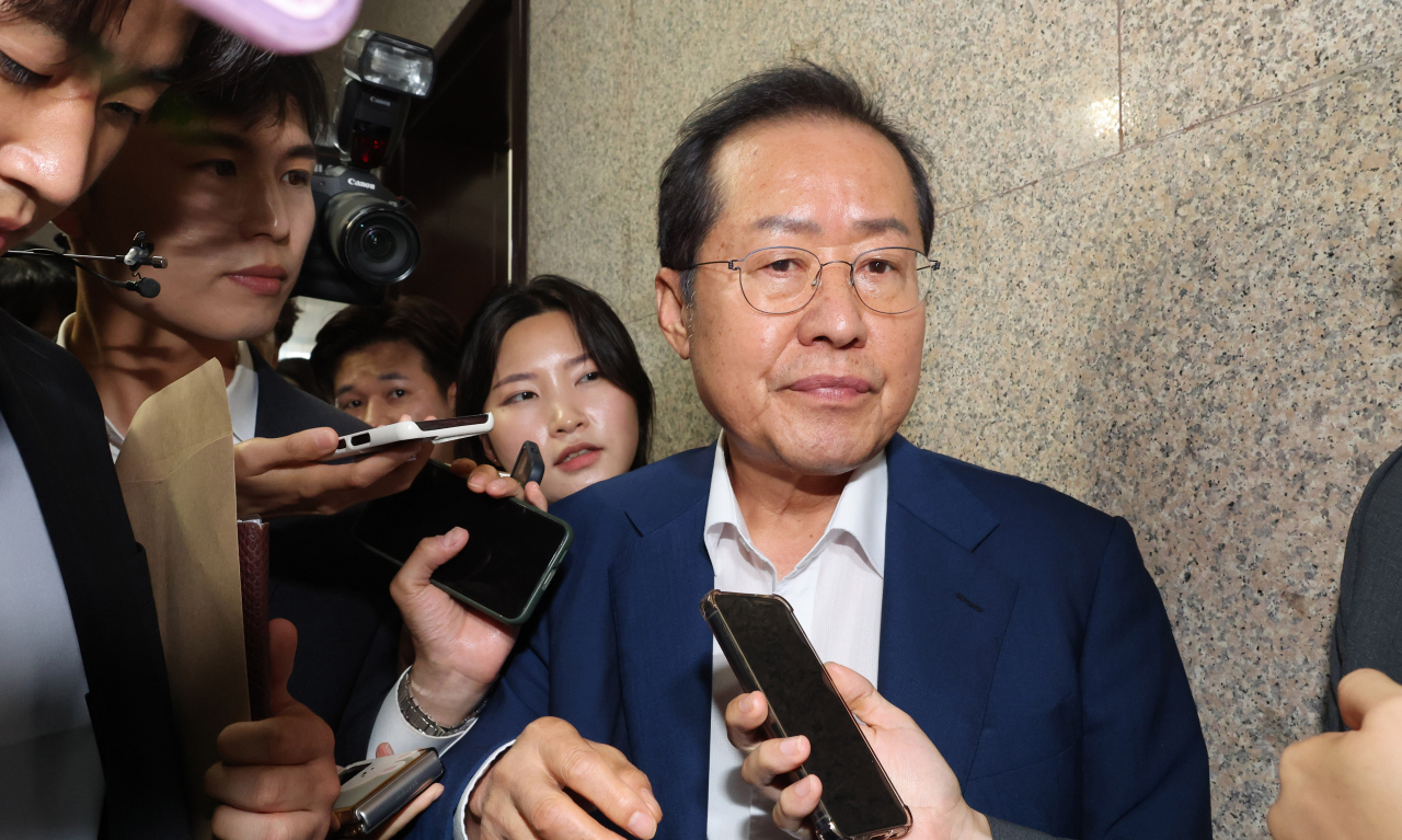 Daegu Mayor Hong Joon-pyo is surrounded by reporters at the National Assembly in Seoul on Monday. (Yonhap)