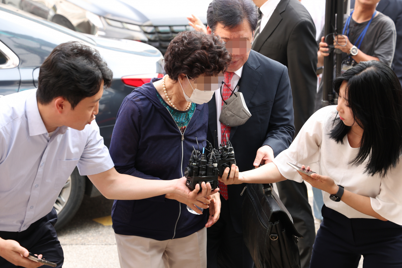 President Yoon Suk Yeol's mother-in-law, center, enters the Uijeongbu District Court on Friday. (Yonhap)
