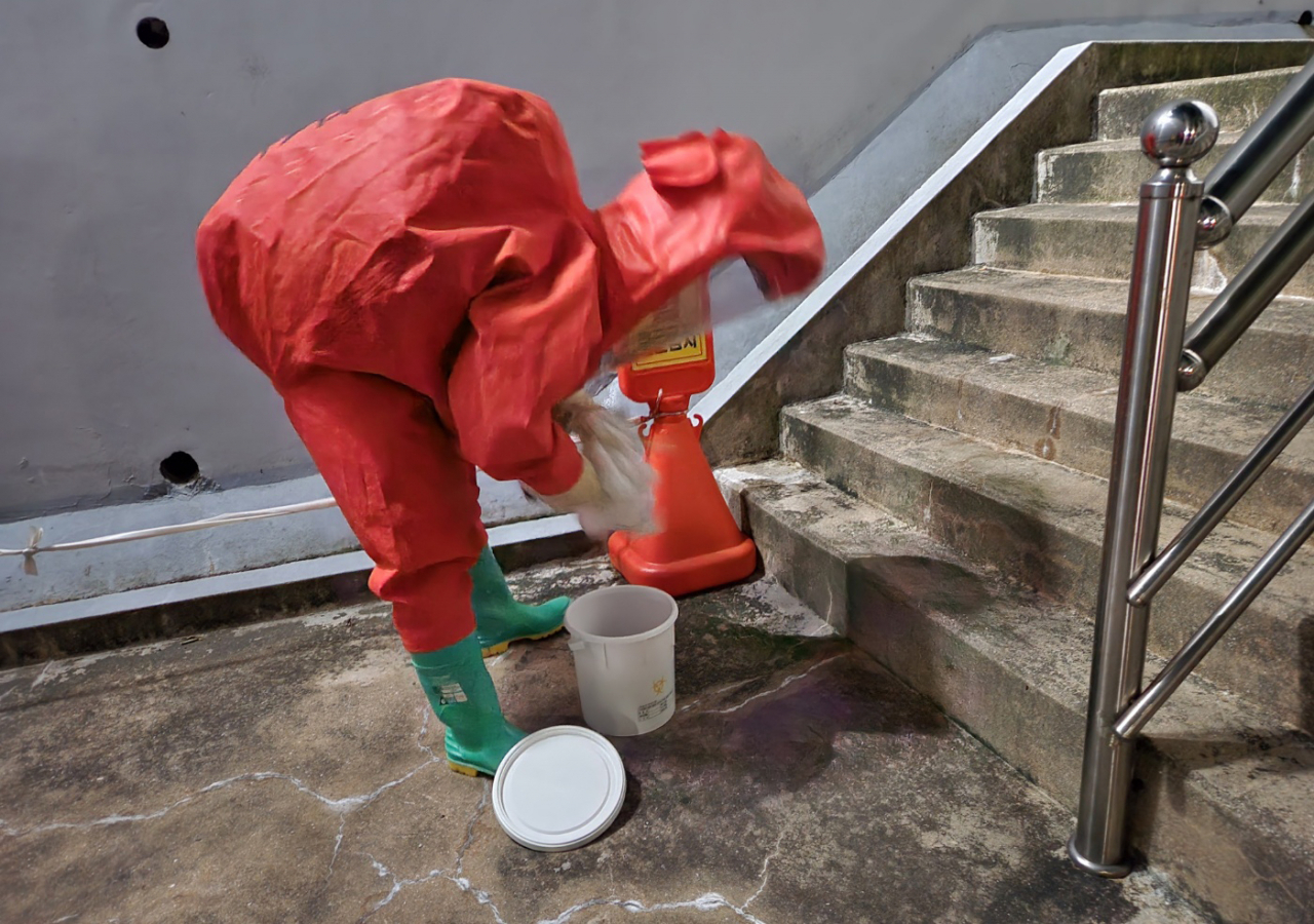 A firefighter collects an unspecified international package delivered to a home in Busan on Saturday (Yonhap)