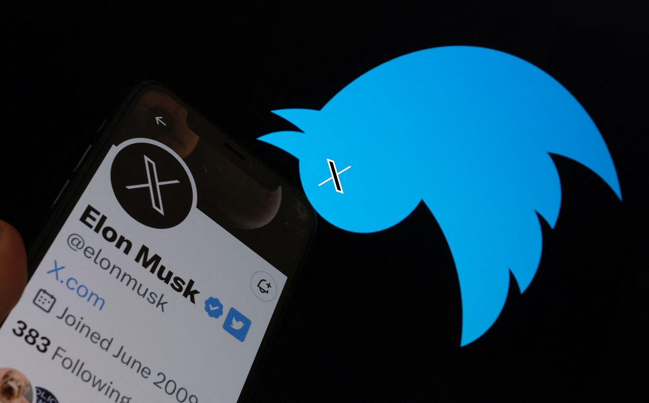 This illustration photo taken on Monday shows the Twitter bird logo upside down in the background of Elon Musk's screen advertising an 