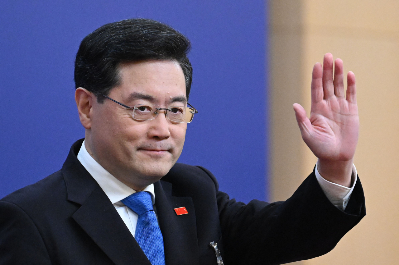 (FILE) China's Foreign Minister Qin Gang waves as he arrives for a press conference at the Media Center of the National People's Congress in Beijing on March 7, 2023. (AFP)