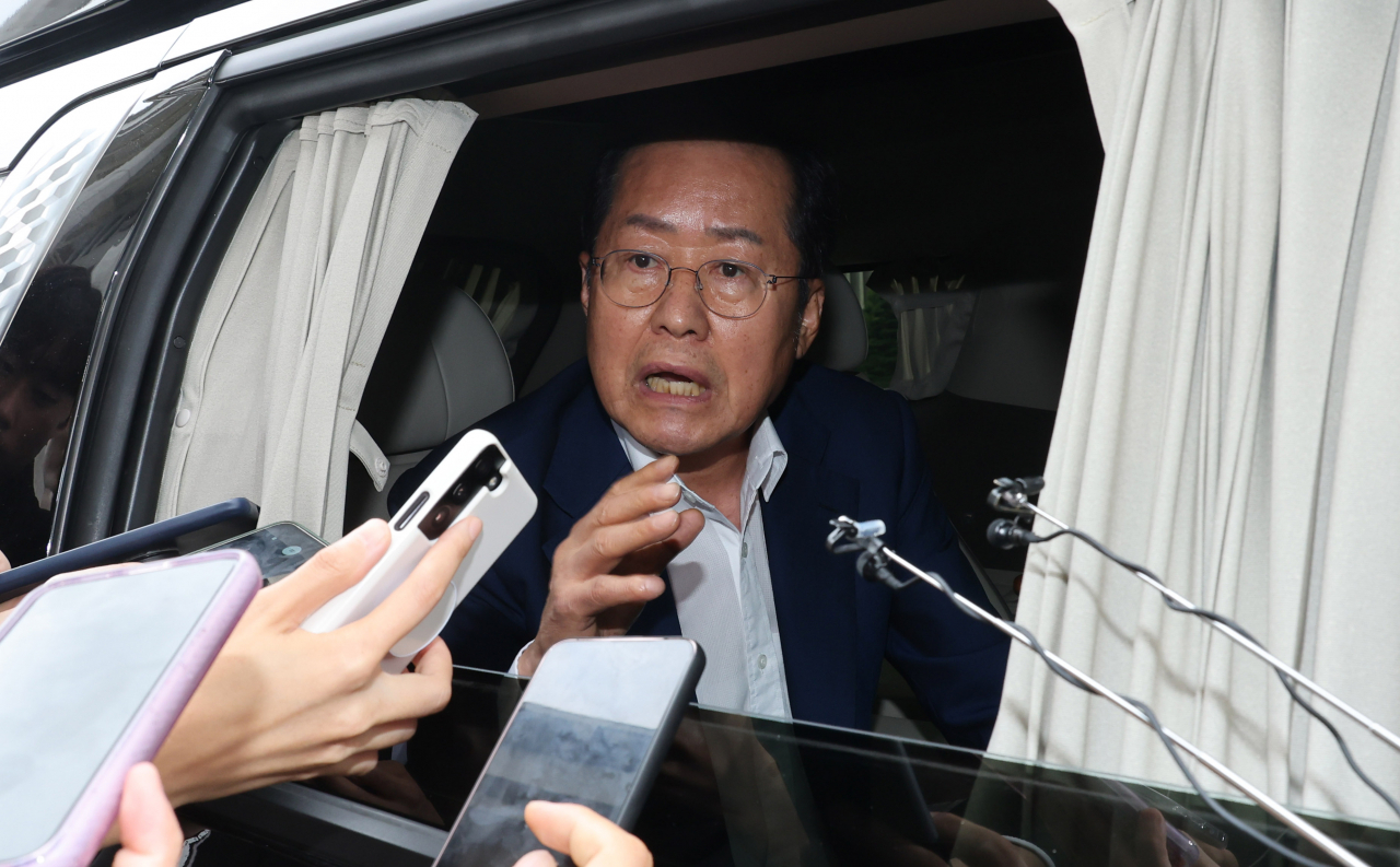 Daegu Mayor Hong Joon-pyo answers reporters' questions while leaving the National Assembly in Seoul, in this file photo taken on July 17. (Yonhap)