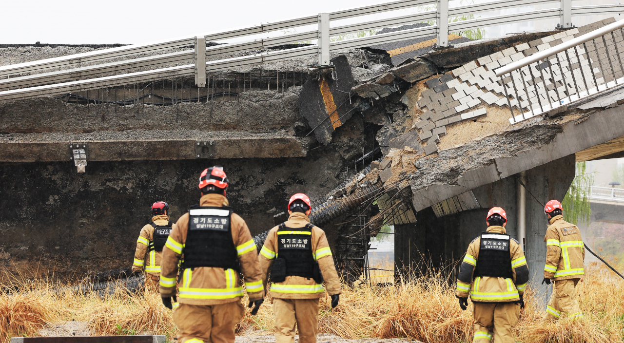 Rescue workers scour the site of a bridge collapse in Jeongja-dong in Seongnam, Gyeonggi Province, that left one dead and one injured, in this April 6, 2023 file photo. (Yonhap)