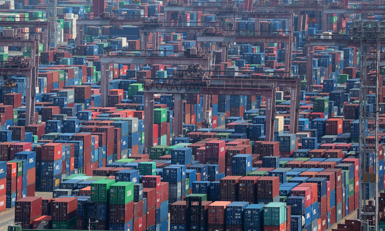 Containers for exports and imports are stacked at a pier in Busan, country's largest port city. (Yonhap)