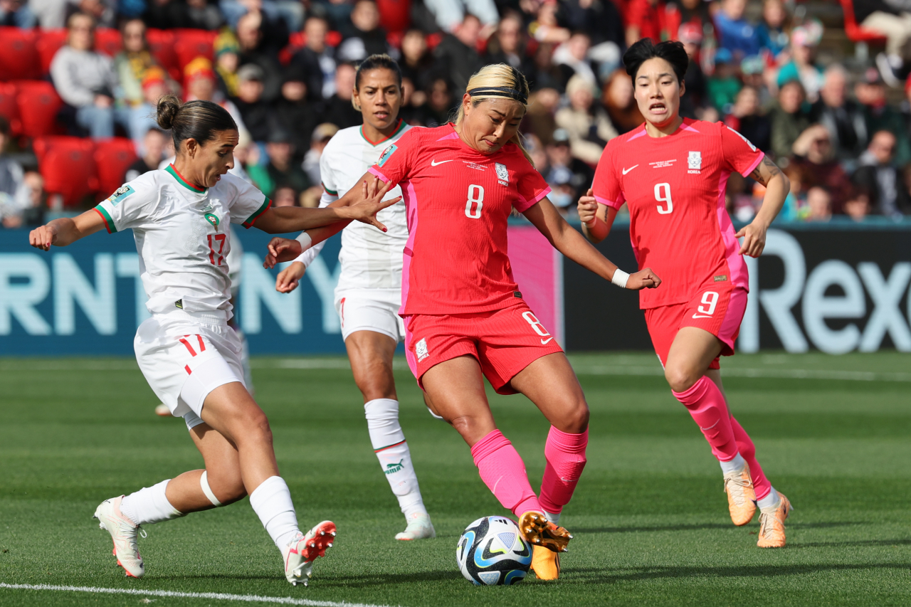 Cho So-hyun of South Korea, center, tries to dribble past Hanane Ait El Haj of Morocco, left, during the teams' Group H match at the FIFA Women's World Cup at Hindmarsh Stadium in Adelaide, southern Australia, on Sunday. (Yonhap)
