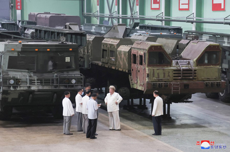 North Korean leader Kim Jong-un is seen giving field guidance at a missile transport erector, or TEL, production facility in this photo carried by North Korea's state-run Korean Central News Agency on Sunday. (Yonhap)