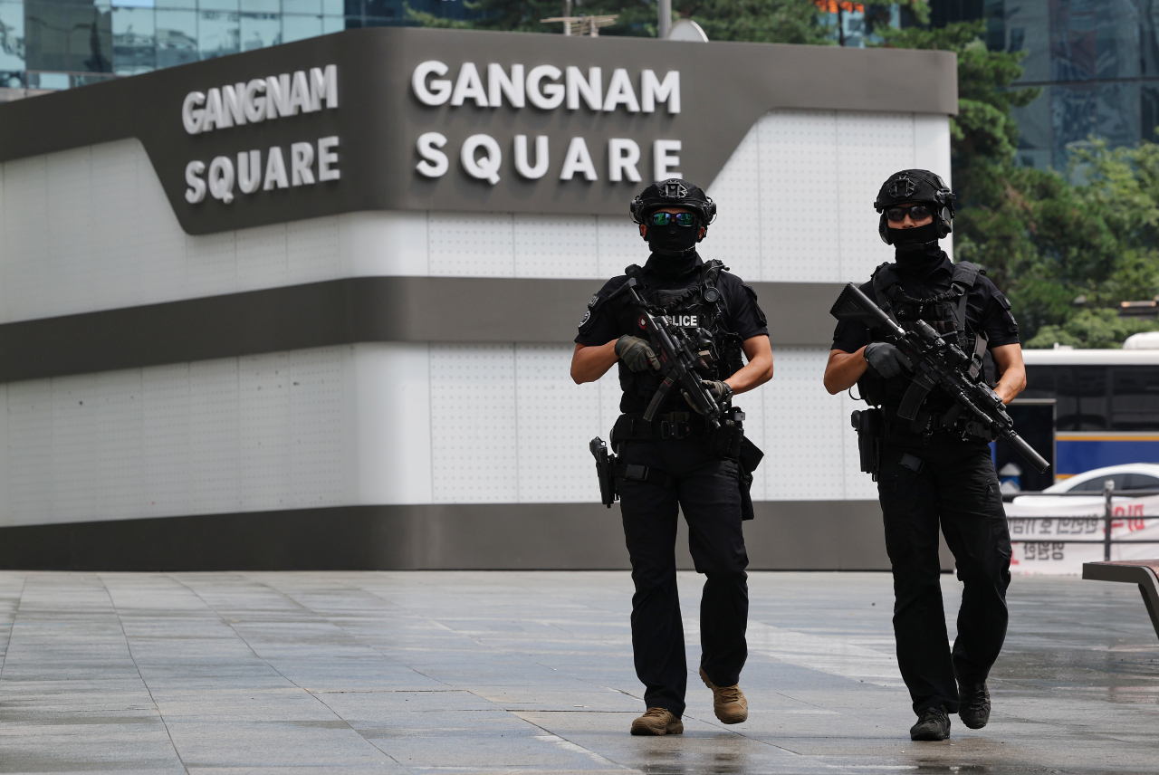 Police officers guard near the Gangnam station in southern Seoul on Sunday. (Yonhap)